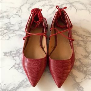 Textured red faux leather flats with ties